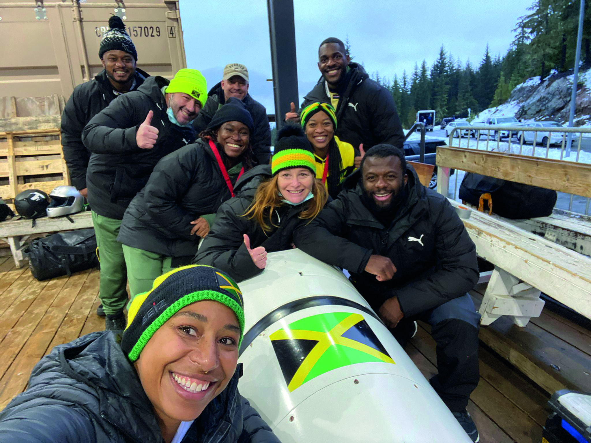Shanwayne with colleagues and a Bobsleigh.